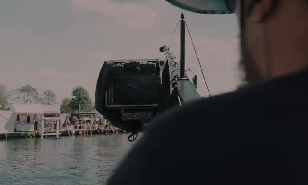 Camera operator covering the racing from the river at Henley Royal Regatta